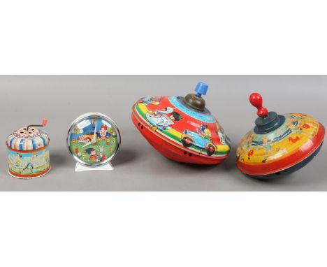 A collection of four tin plate toys to include two Chad Valley spinning tops, West German musical box and a Smiths Noddy alar