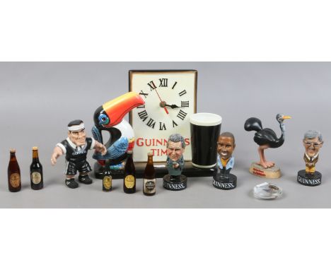 A collection of Guinness memorabilia to include ceramic clock, collectable figurine, small bottles of Guinness etc.