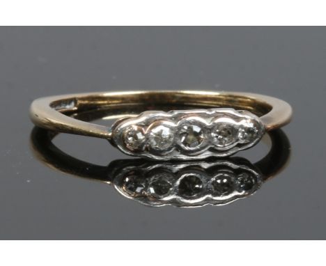 A 9ct gold and platinum five stone diamond ring. Size M.