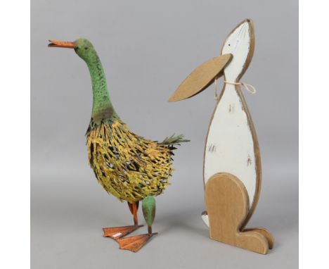 A decorative painted tin model of a goose and a painted plywood model of a hare.