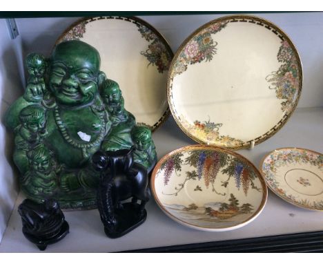 Two modern Satuma side plates with two smaller examples- one damaged together with a green ceramic Buddha style figure and tw