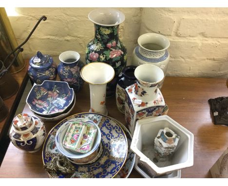 A selection of ceramic vases, pots and plates with oriental designs.