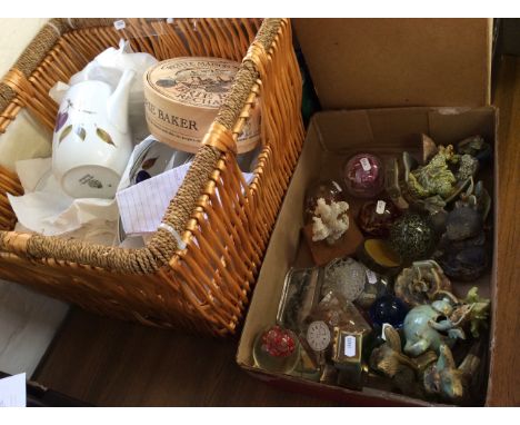 A crate of glass paperweights and ceramic ornaments as well as a basket of royal Worcester chinaware.