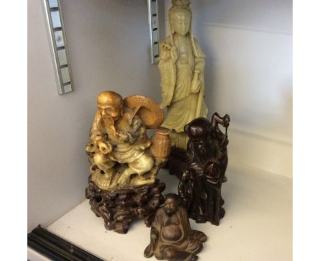 Two soap stone carved figures, one a female deity, the other a seated man together with a resin study of an of Chinese man an
