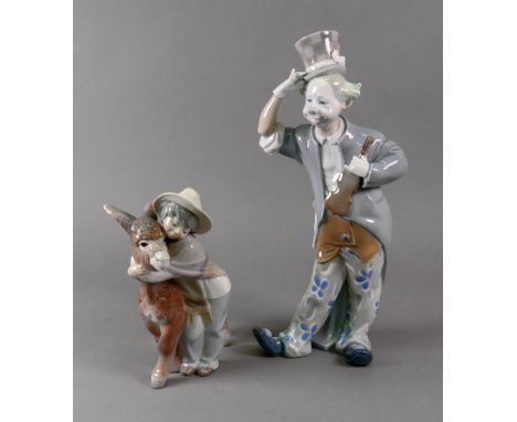 A Lladro figure of a clown musician, with violin, 01001126, 35cm high and a Lladro boy with donkey, D4154, 21cm high (2).
