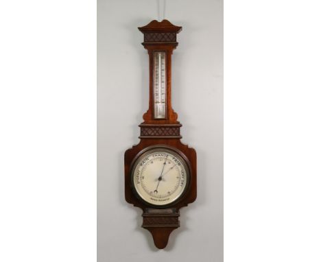 A mahogany cased barometer thermometer, circa 1915, blind fret carved, 87cm high, with applied presentation inscription.
