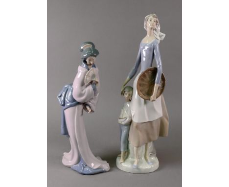 A Nao Japanese lady with fan, 33.5cm high and another of a young woman with her son at her side holding a model yacht, 40.5cm