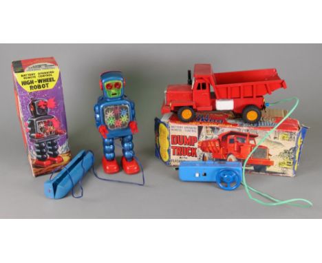 A tin plate battery operated remote control dump truck and a KO battery operated remote control High-Wheel Robot, both in ori
