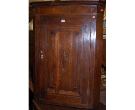 A George III oak and mahogany crossbanded single door hanging corner cupboard; together with a Victorian hinged top commode (