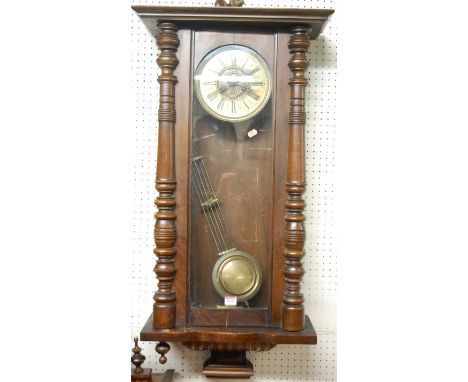 An early 20th century walnut Vienna drop trunk wall clock