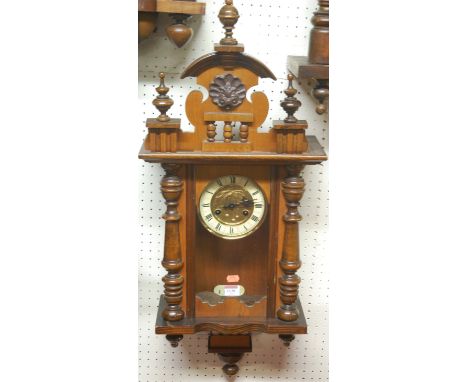 A small early 20th century walnut cased Vienna drop trunk wall clock