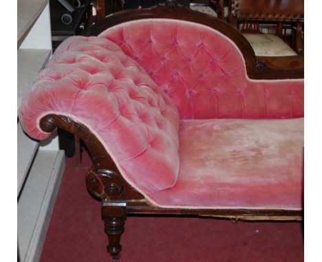 A late Victorian walnut framed and pink button back upholstered chaise longue