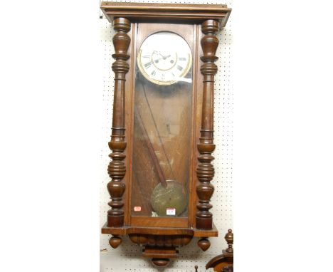 An early 20th century walnut Vienna drop trunk wall clock