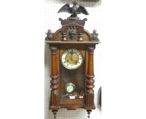 An early 20th century walnut cased Vienna drop trunk wall clock