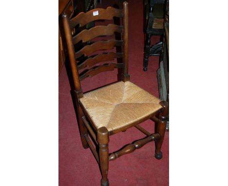A set of six reproduction elm ladder back dining chairs each having rush seats