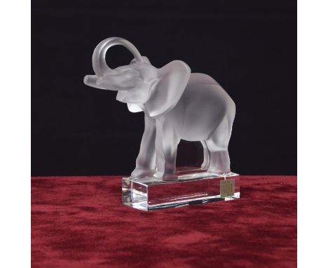 Lalique moulded clear and frosted glass model of an elephant, with a raised trunk upon a plinth base, signed and bearing the 