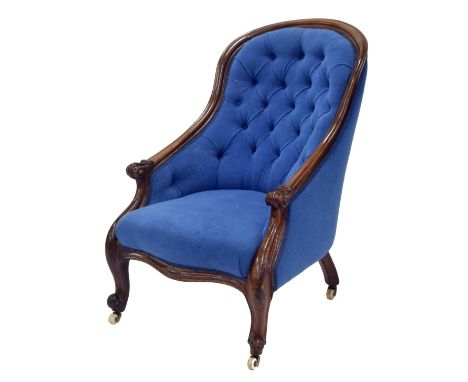 Victorian mahogany blue button-back spoon back armchair, with cabriole legs terminating with white ceramic castors, 26" wide,