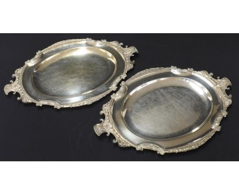 Pair of Elkington silver plated oval meat serving plates, with cast foliate and sheep head mounts within beaded borders, 19.5