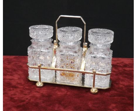 Atkin Brothers silver plated pickle set, inset with three cut-glass jars and stoppers in a plated mount with a swing handle, 