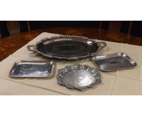 Good large silver plated engraved twin-handled serving tray, with a cast foliate shaped border upon scroll feet, 30" wide, 21