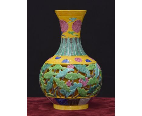 Chinese porcelain bottle vase, with reticulated floral decoration upon a yellow scaled ground, impressed Qianlong seal mark, 