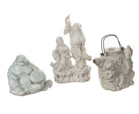 A GROUP OF THREE BLANC-DE-CHINE FIGURES,  including a group of two Immortals figures, one depicted with a long beard and wear