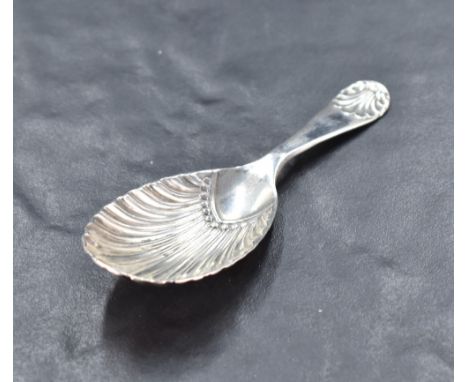 An Edwardian silver caddy spoon, of scalloped oval form, the short handle with scalloped terminal, marks for Sheffield 1901, 