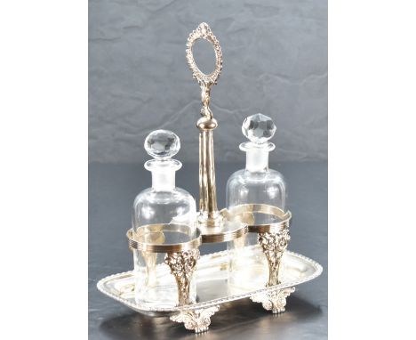 A late Victorian silver two-bottle oil and vinegar cruet, having a central raised handle between two circular bottle division