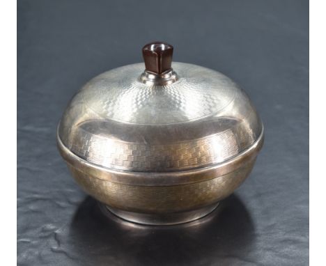 A George V silver mounted bakelite dressing table powder box, of compressed spherical form with bakelite handle and engine-tu