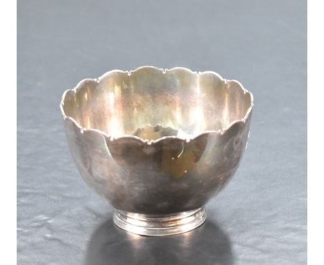 An unusual 20th century Irish silver bowl, of plain dished cylindrical form with lobed rim and short moulded foot, marked for