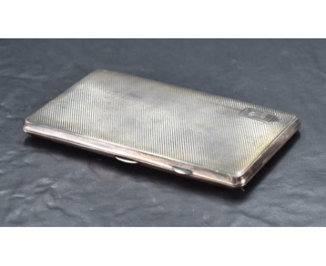 A George VI silver cigarette case, of hinged rectangular form, engine turned throughout, with geometric cartouche engraved wi