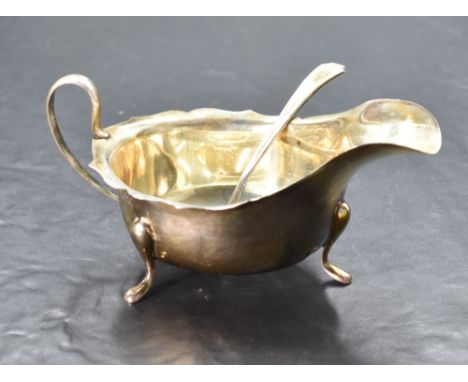 A George V silver gravy boat, of traditional design, marks for Sheffield 1934, maker Viners, 14.5cm, 101grams sold together w