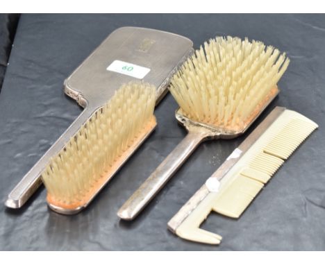 A George VI silver backed four-piece brush set, of Art Deco influenced design, comprising hand mirror, hair brush, clothes br