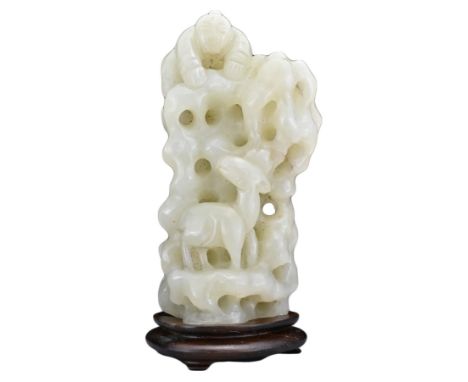 A CHINESE PALE CELADON JADE CARVING ON WOODEN STAND. Carved and pierced in the form of a rock formation with boy and deer. Ja