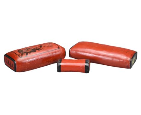 THREE CHINESE RED LACQUER PILLOWS, 19/20TH CENTURY. Each stuffed with added decoration and calligraphy. 17cm, 33cm and 37cm l