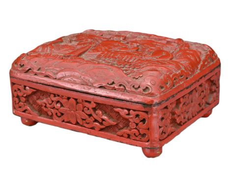 A CHINESE RED LACQUER AND ENAMEL BOX. The rectangular box with hinged cover carved in relief with figures under a pine tree w