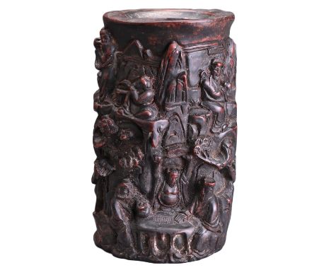 A CARVED WOODEN BRUSH POT WITH 'EUROPEAN FIGURE'. Carved in deep relief with various figures on mountain side with pine trees