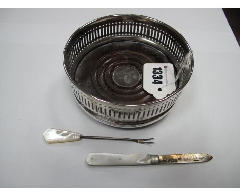 A Hallmarked Silver and Mother of Pearl Folding Fruit Knife; together with a pickle fork and a bottle coaster, bearing facsim