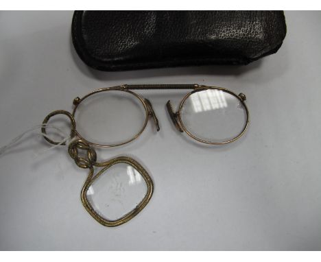 A Gold Plated Lorgnette (Quizzing Glass), with handle designed as a "Hercules Knot", together with a pair of pince-nez in lea