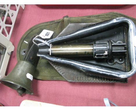 A US Army Folding Spade, in protective canvas case and a hand bell. (2)
