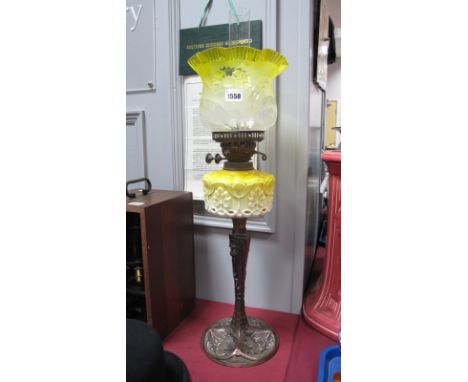 An Art Nouveau Oil Lamp, with naturalistic decoration to oxidized copper base, stamped J.H & Co Ltd in yellow and cream glass