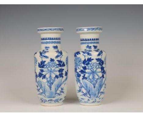 China, a pair of blue and white porcelain vases, 19th century, each decorated with birds in flower garden, the bases with apo