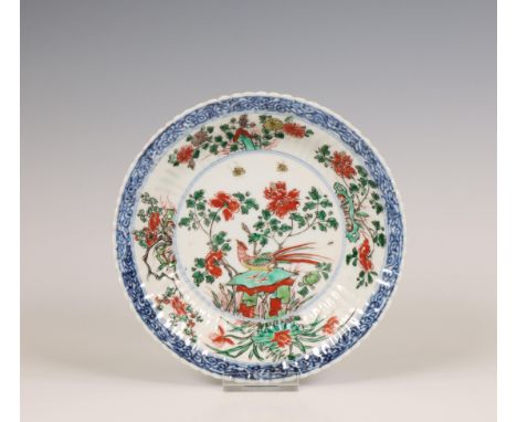 China, famille verte porcelain dish, Kangxi period (1662-1722), with ribbed sides and painted with a pheasant perches on a ro