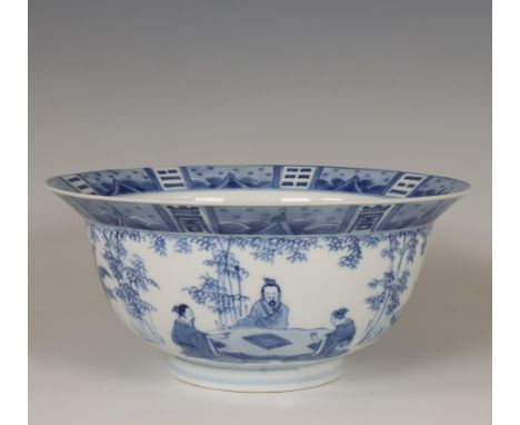 China, a blue and white porcelain bowl, Kangxi period (1662-1722), modelled with everted rim, the exterior painted with schol