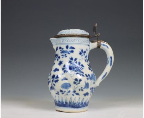 China, a blue and white porcelain gadrooned ewer and silver-mounted cover, Kangxi period (1662-1722), the silver later, the t