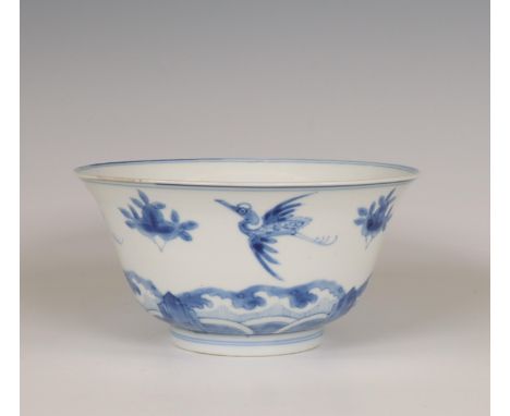 China, a blue and white porcelain bowl, Kangxi period (1662-1722), decorated with cranes and clusters of peach above crashing