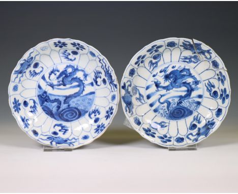 China, a near pair of blue and white 'dragon and carp' plates, Kangxi period (1662-1722), each painted with a dragon emerging