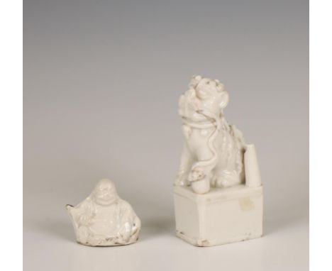 China, a Dehua porcelain joss-stick holder and a whistle, 18th century, the joss-stick holder modelled as a Buddhist lion on 