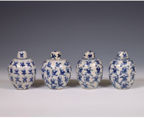 China, four soft paste blue and white 'one hundred boys' jarlets and covers, 19th century, each painted with a dense pattern 