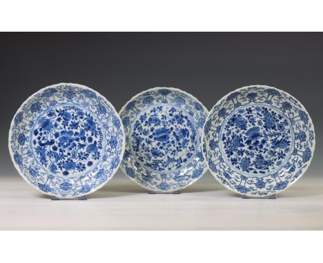 China, set of three blue and white porcelain 'lotus' dishes, Kangxi period (1662-1722), each painted with central floral roun